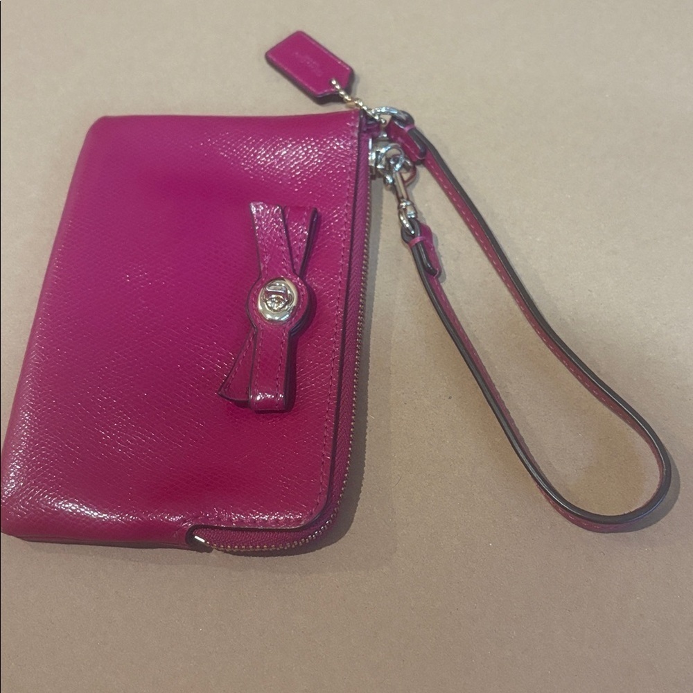 Coach wristlet with bow turn lock in cranberry